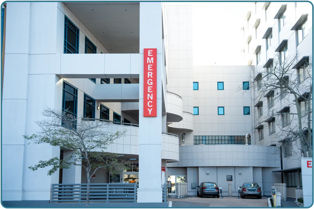 A hospital entrance and its parking area