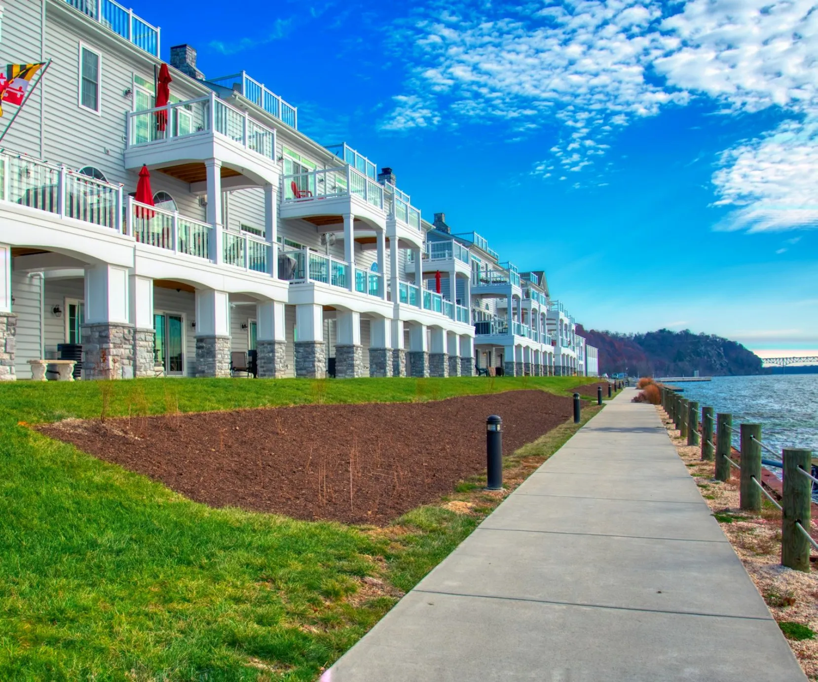 Waterfront apartments along a paved pedestrian path